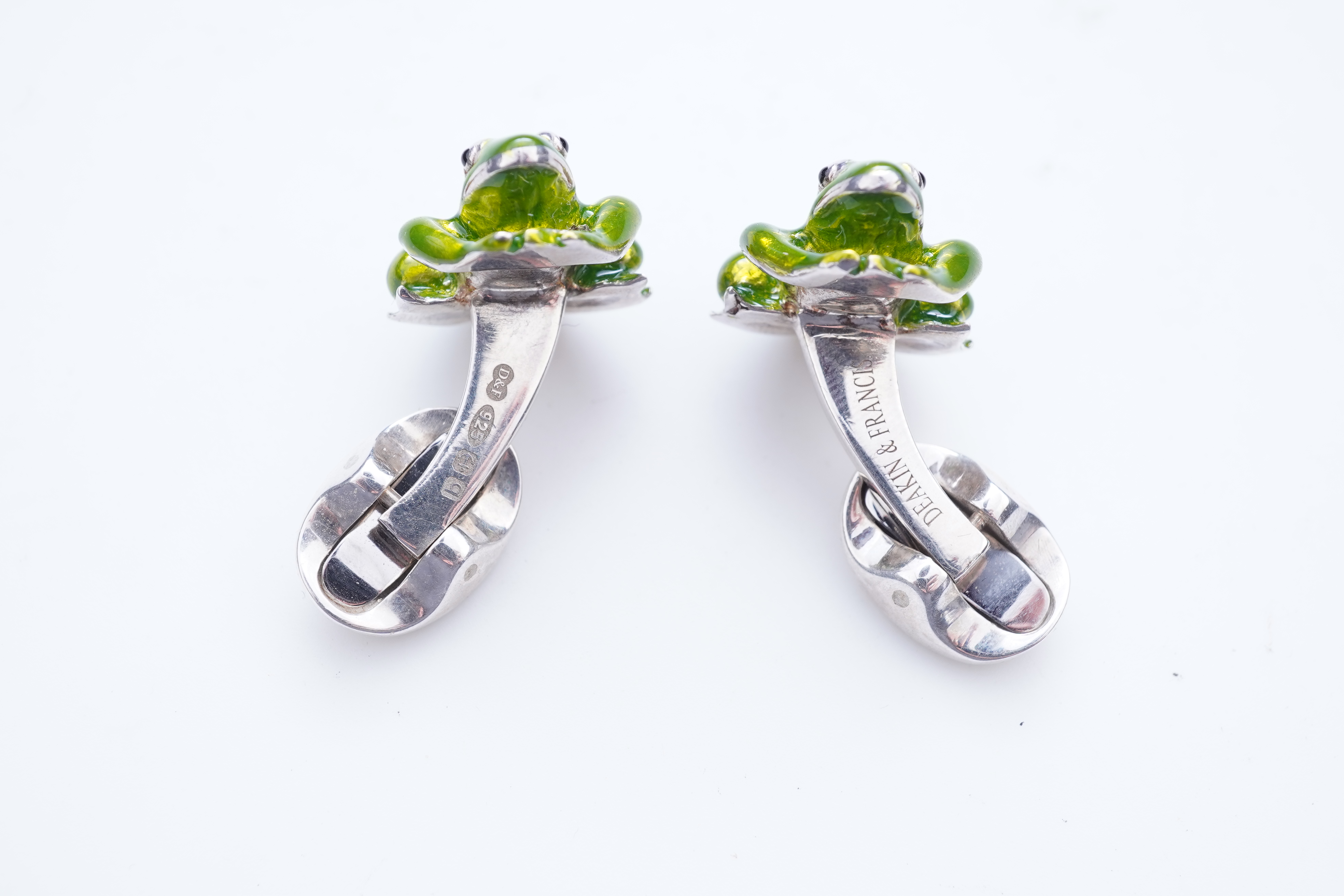 A modern pair of silver and polychrome enamel set oval cufflinks, 18mm.